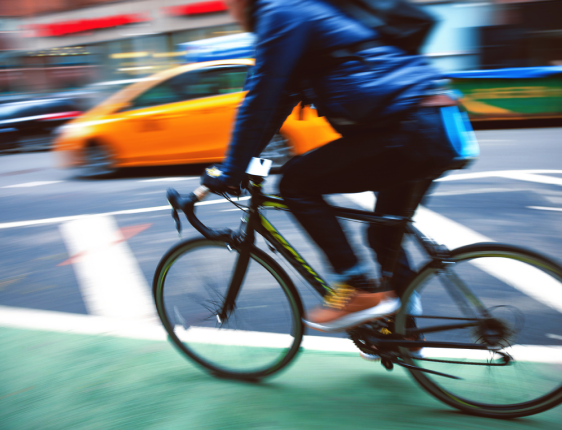 A person riding on a bike through a city