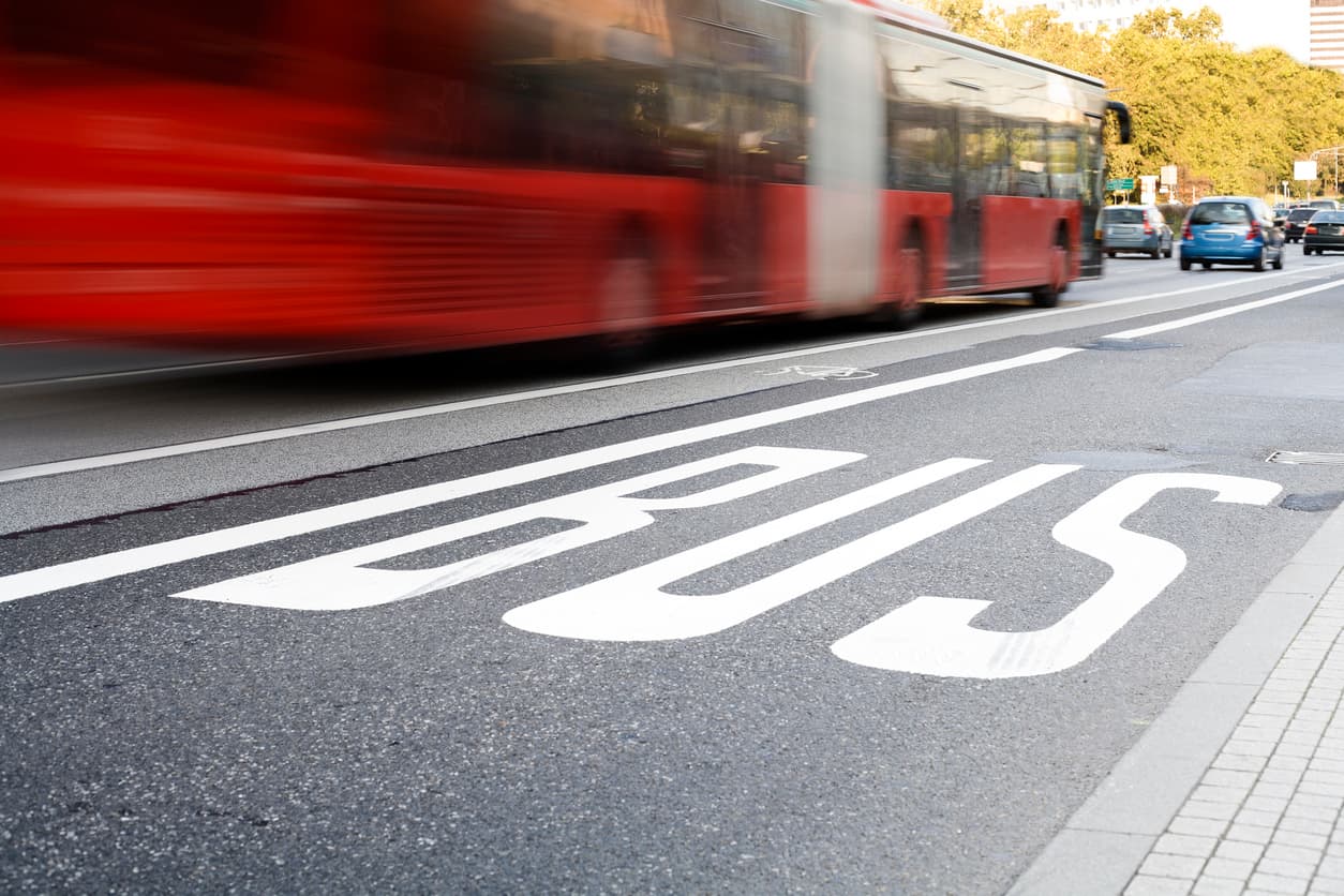 A bus driving through traffic