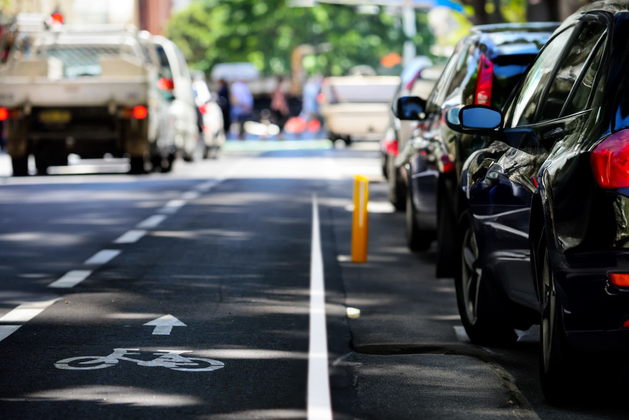 Cars waiting in traffic beside a bike lane