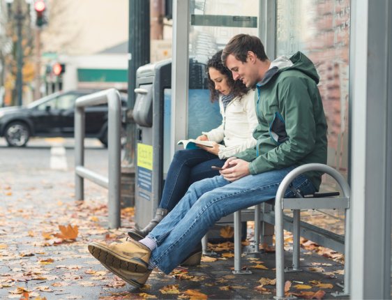 Couple sitting at a bus stop