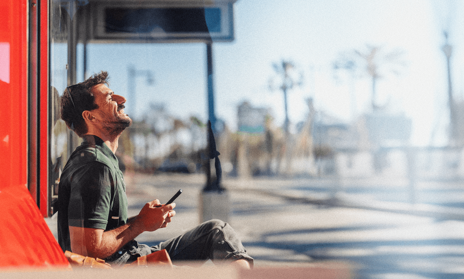 A man sitting on a bench outside